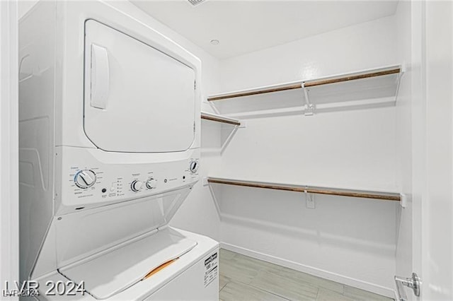 laundry area with stacked washer / dryer