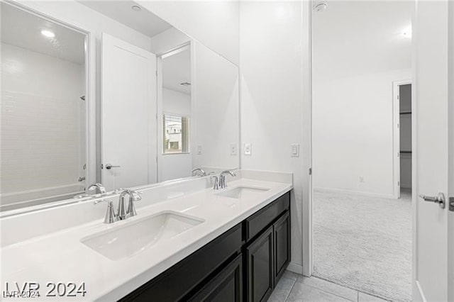 bathroom with bathing tub / shower combination, tile patterned flooring, and vanity