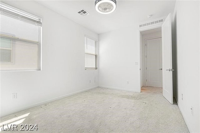 unfurnished room with light carpet