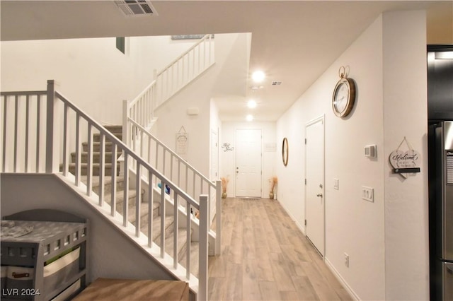 stairs featuring hardwood / wood-style flooring