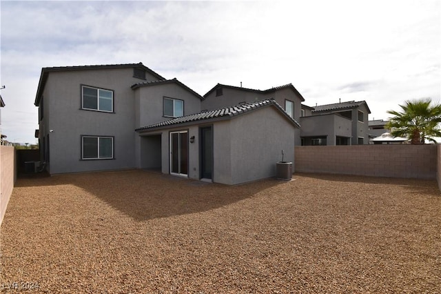 rear view of house with central AC unit