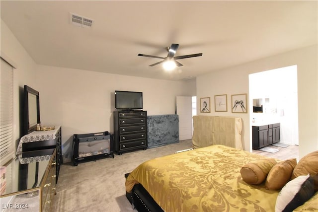 carpeted bedroom featuring ensuite bathroom and ceiling fan