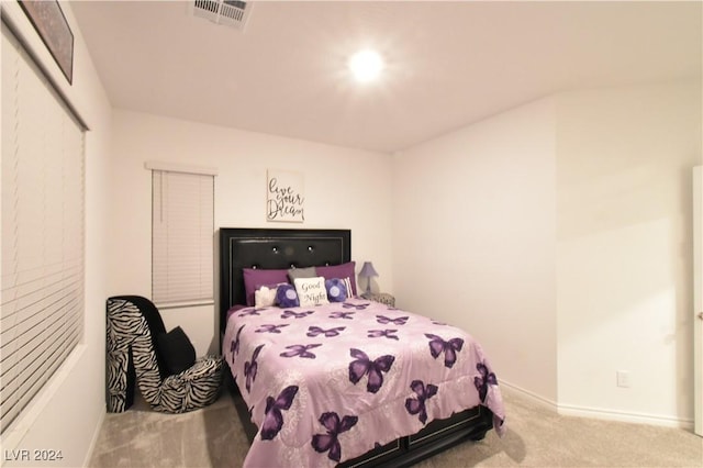 bedroom featuring light carpet