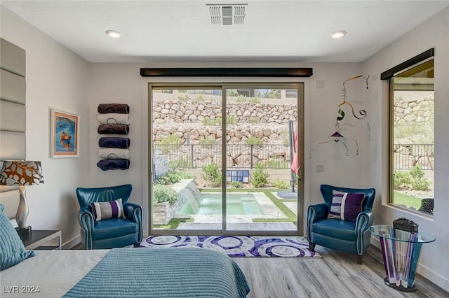 bedroom with light hardwood / wood-style floors and access to exterior