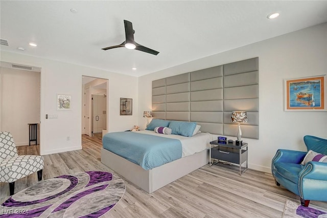 bedroom with ceiling fan and light hardwood / wood-style floors