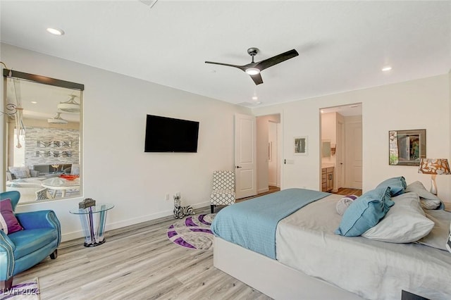 bedroom featuring ceiling fan, light wood-type flooring, and connected bathroom