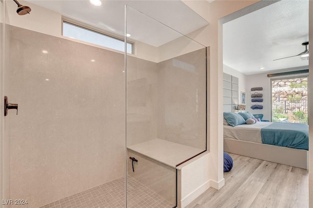 bathroom with a shower, built in shelves, hardwood / wood-style flooring, and ceiling fan