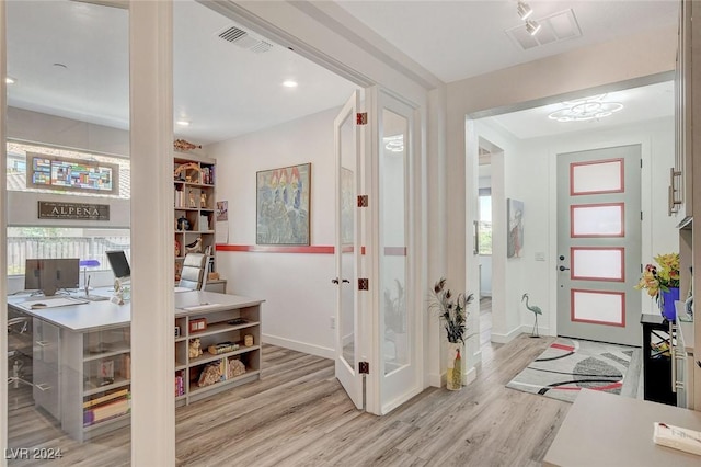 foyer entrance with light wood-type flooring