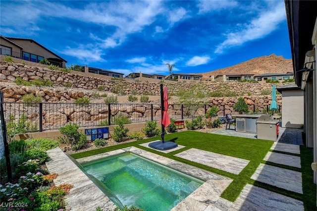 view of pool with a patio area, a yard, and a jacuzzi