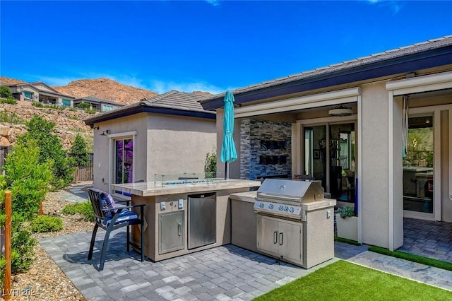 view of patio featuring area for grilling and exterior kitchen