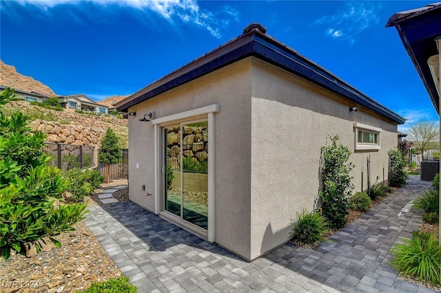 view of property exterior featuring a patio area