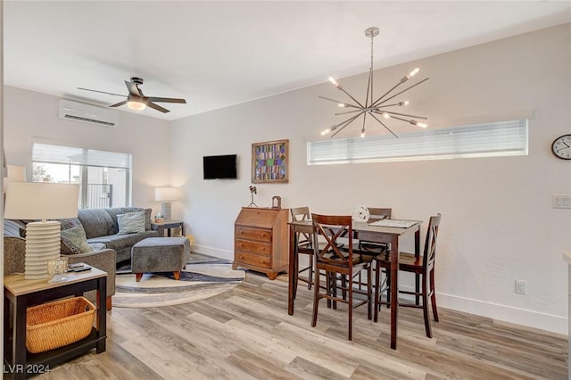 dining space with ceiling fan with notable chandelier, light wood-type flooring, and an AC wall unit