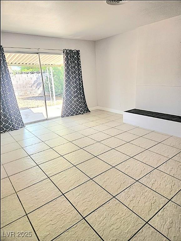 spare room with tile patterned flooring