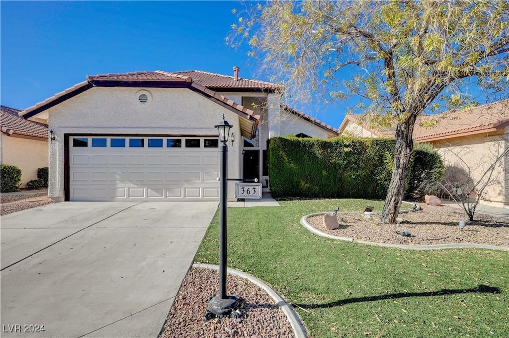 view of front facade with a garage and a front lawn