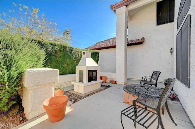 view of patio featuring a multi sided fireplace