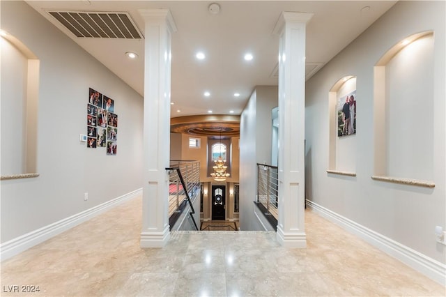 corridor featuring decorative columns