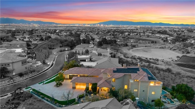 aerial view at dusk featuring a mountain view