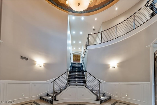 staircase with a high ceiling