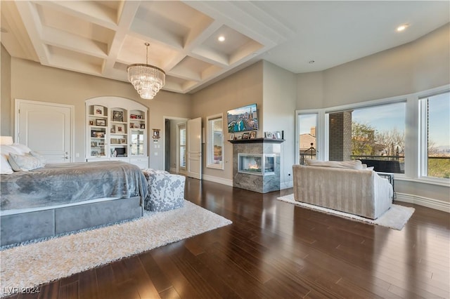 bedroom with beam ceiling, dark hardwood / wood-style flooring, a notable chandelier, and coffered ceiling