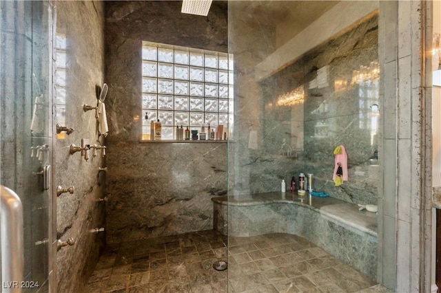 full bath with a tub with marble appearance and a marble finish shower