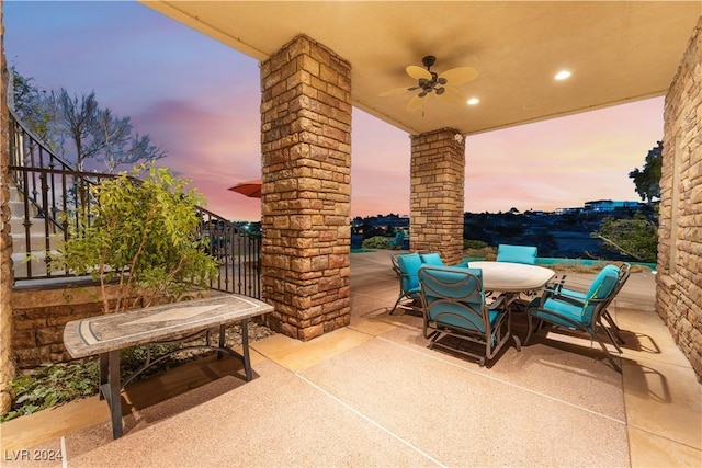 patio terrace at dusk featuring ceiling fan