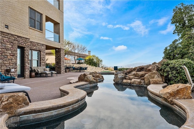 view of pool featuring a patio