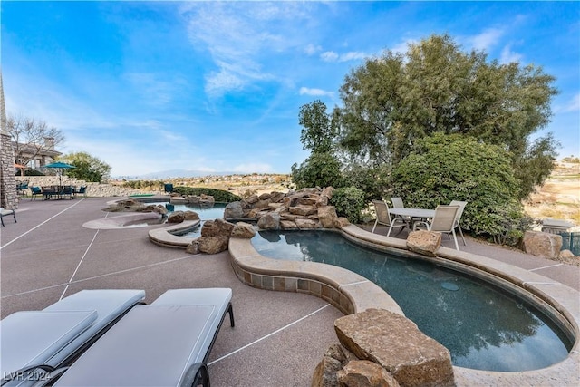 view of swimming pool with a patio