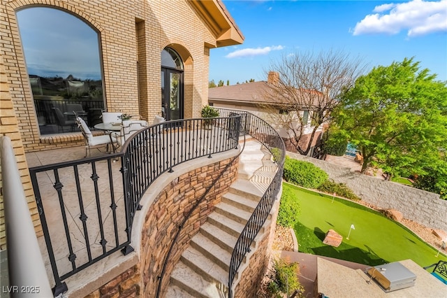 exterior space with a patio and brick siding