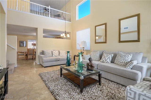 tiled living room with a notable chandelier and a towering ceiling