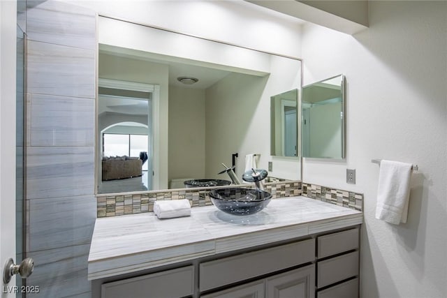 bathroom featuring tasteful backsplash and vanity