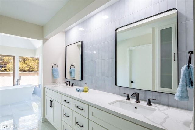 full bathroom featuring double vanity, a soaking tub, tile walls, and a sink