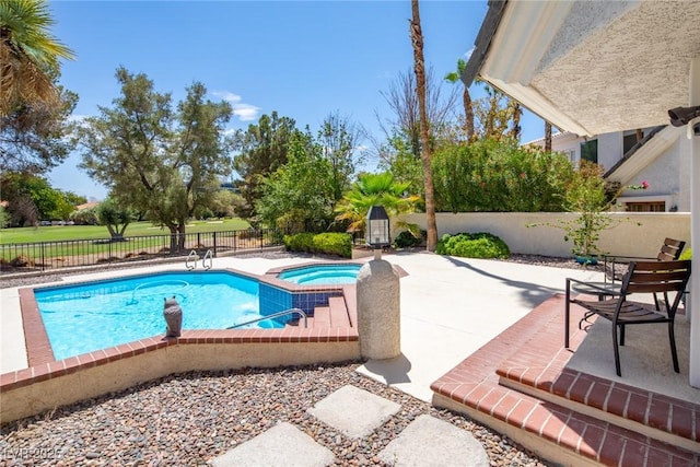 view of pool featuring a pool with connected hot tub, a fenced backyard, and a patio