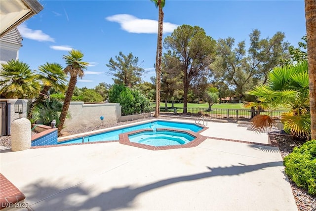 view of swimming pool featuring a patio area, a fenced backyard, and a pool with connected hot tub