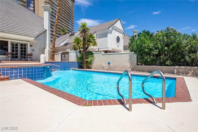 view of swimming pool with a patio area, fence, a fenced in pool, and french doors