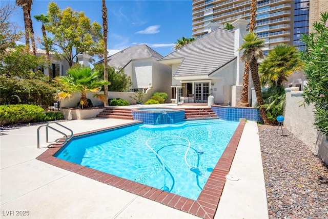 view of pool featuring a pool with connected hot tub, a fenced backyard, and a patio