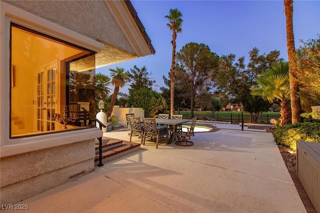 view of patio with outdoor dining area and fence