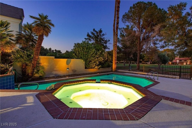 view of pool featuring an in ground hot tub, a patio area, a fenced backyard, and a fenced in pool