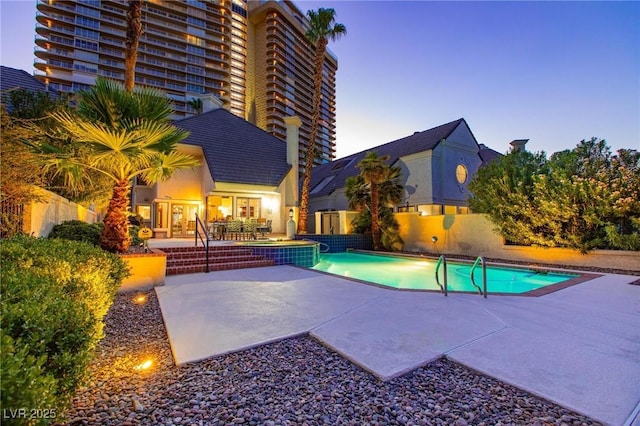 view of swimming pool featuring a patio area, fence, and a fenced in pool