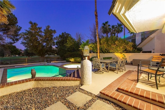 view of swimming pool with a fenced in pool, a patio area, fence, and an in ground hot tub