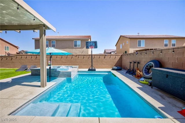 view of swimming pool with an in ground hot tub and a patio area