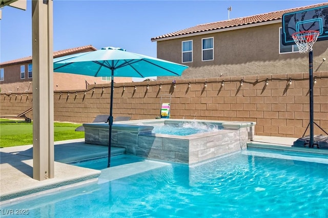 view of pool featuring an in ground hot tub