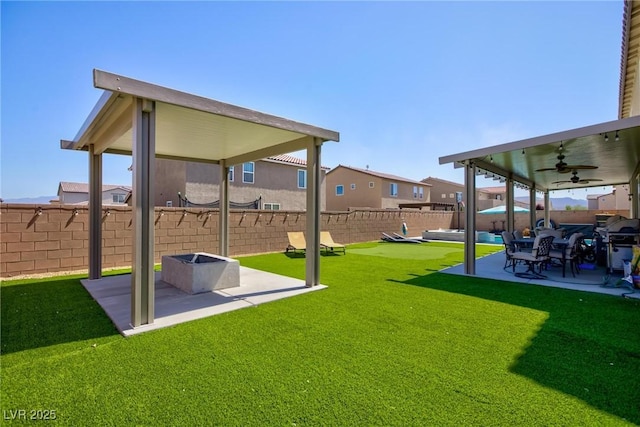 view of yard with ceiling fan and a patio area