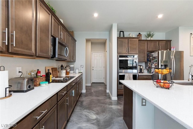 kitchen with stainless steel appliances and dark brown cabinets