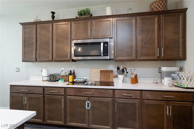 kitchen featuring dark brown cabinets and black electric stovetop