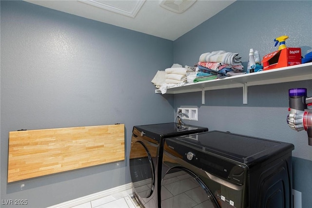 laundry room with tile patterned floors and washing machine and clothes dryer