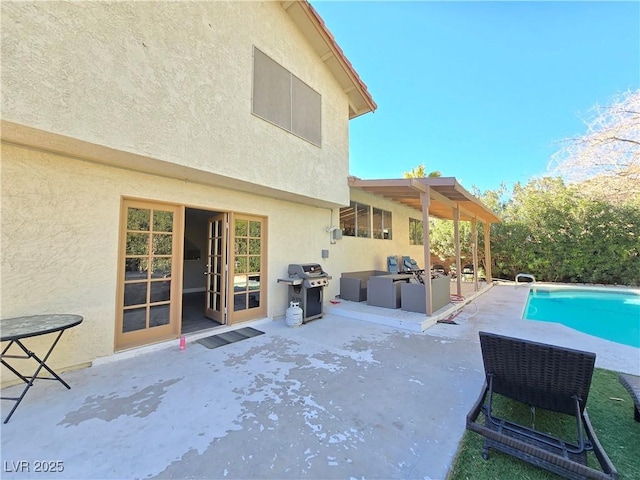 view of pool with a patio and area for grilling