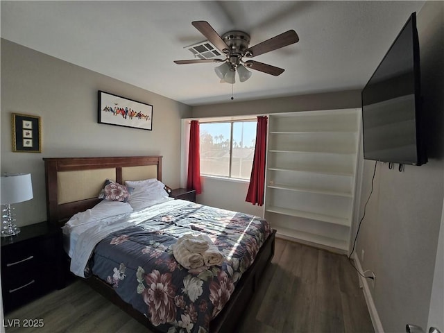 bedroom with dark wood-type flooring and ceiling fan