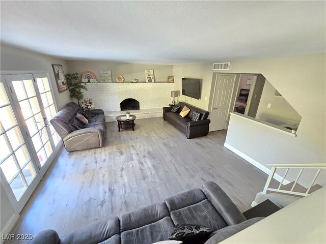 living room with hardwood / wood-style flooring and a fireplace