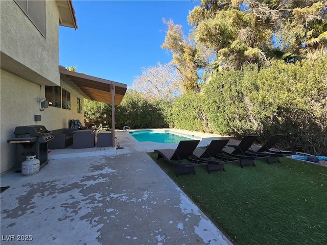 view of swimming pool with a patio area, a grill, and a yard