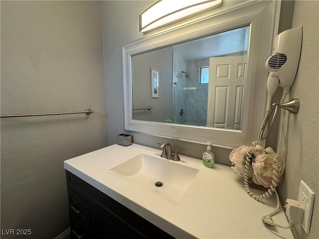 full bath featuring vanity and a shower